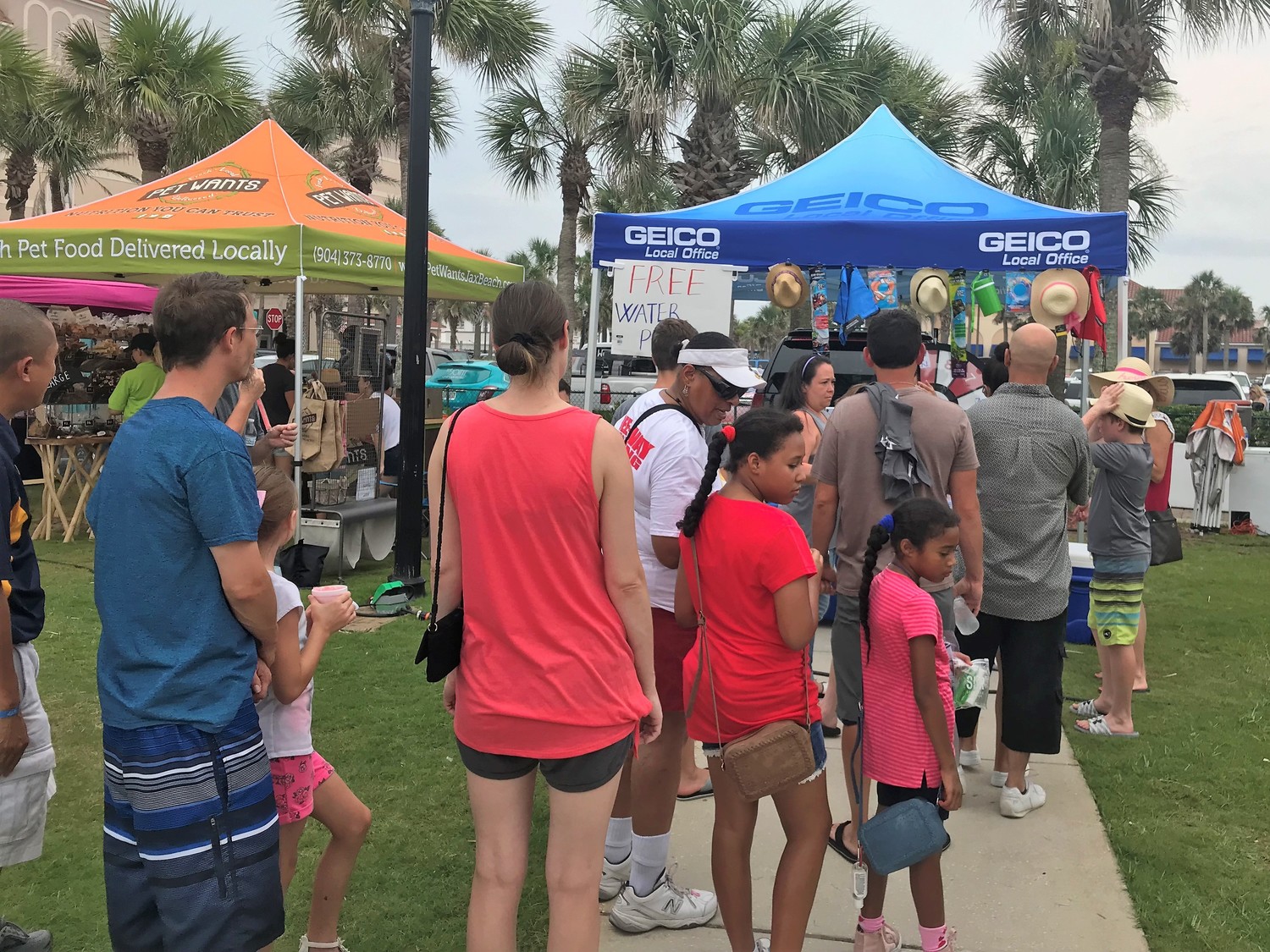 A long line forms in front of Madeline Nguyen’s Geico tent.